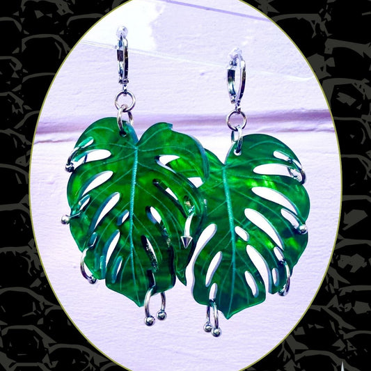 Green leaf-shaped earrings on a white background