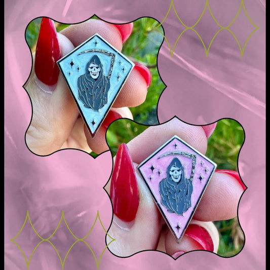 Two tarot card-style pins held by a hand with red nails on a pink background.