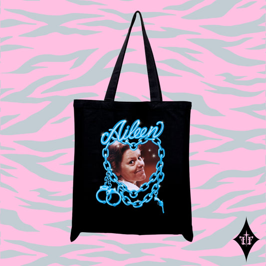 Aileen Wuornos photo and blue chain heart graphic on a black tote bag