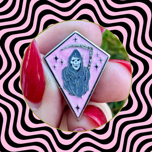 Enamel pin with grim reaper design on pink background, brand 'Foolish Fetish' visible