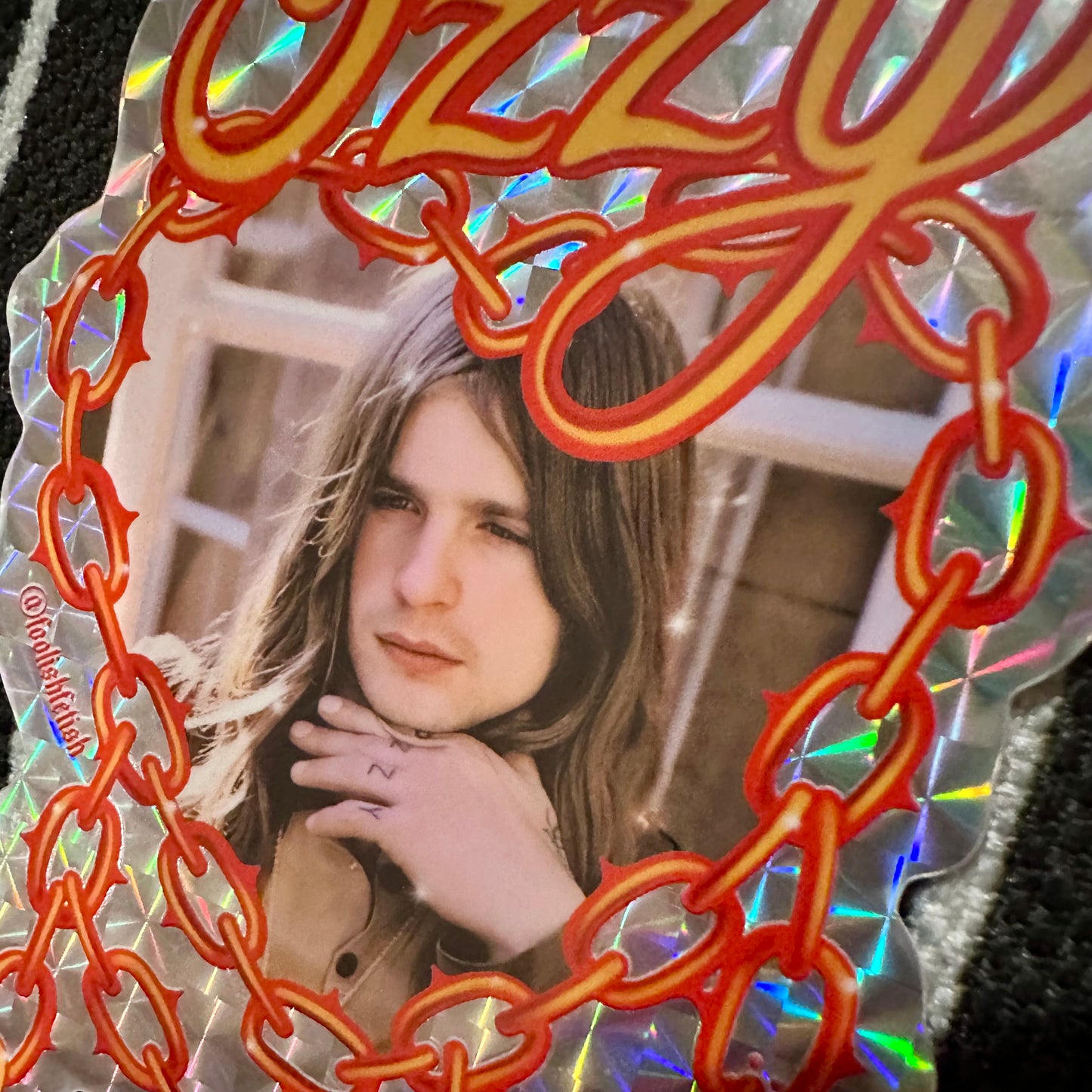 Decorative card with a person's photo and 'Ozzy' text in a decorative frame.