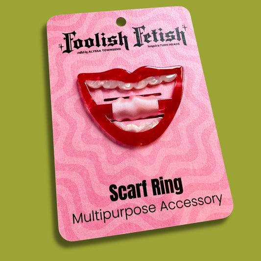 red smile scarf ring on a pink psychedelic card that says Foolish Fetish and scarf ring on a green background