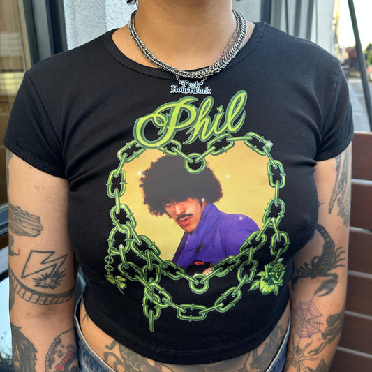 Person wearing a black t-shirt with a graphic design and text.