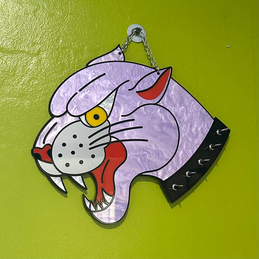 Cartoonish cat head design on a green background