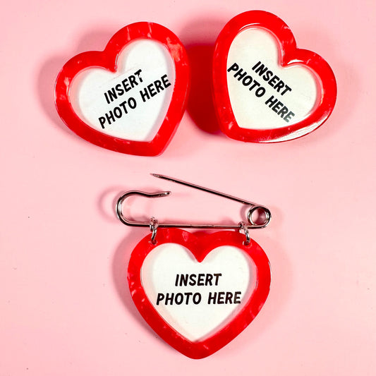 Heart-shaped photo holders with 'Insert Photo Here' text on a pink background
