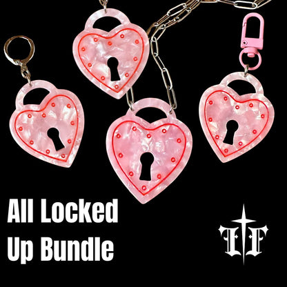 Heart-shaped lock keychains with pink glitter on a black background, featuring the brand 'LF'.