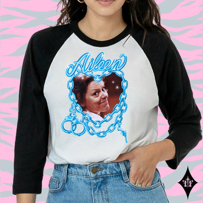 Aileen Wuornos photo and blue chain heart graphic on a black and white raglan shirt