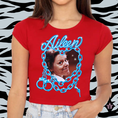 Aileen Wuornos photo and blue chain heart graphic on a women's red crop top