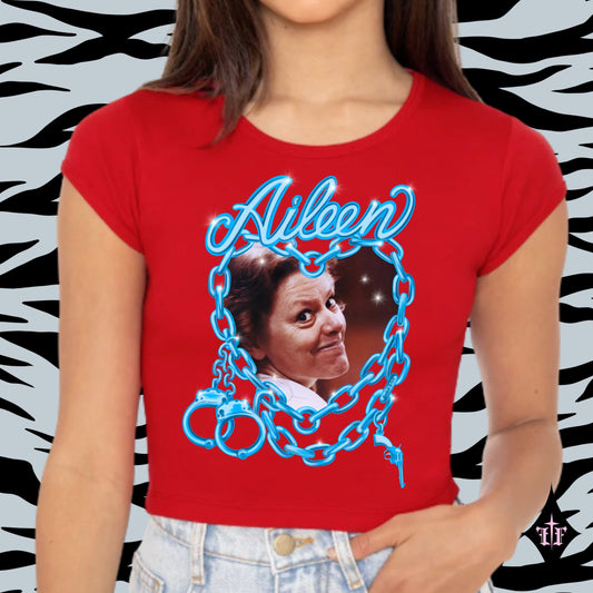 Aileen Wuornos photo and blue chain heart graphic on a women's red crop top