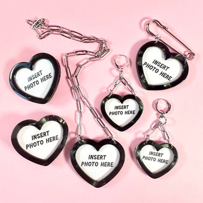 Heart-shaped photo holders with 'insert photo here' text on a pink background
