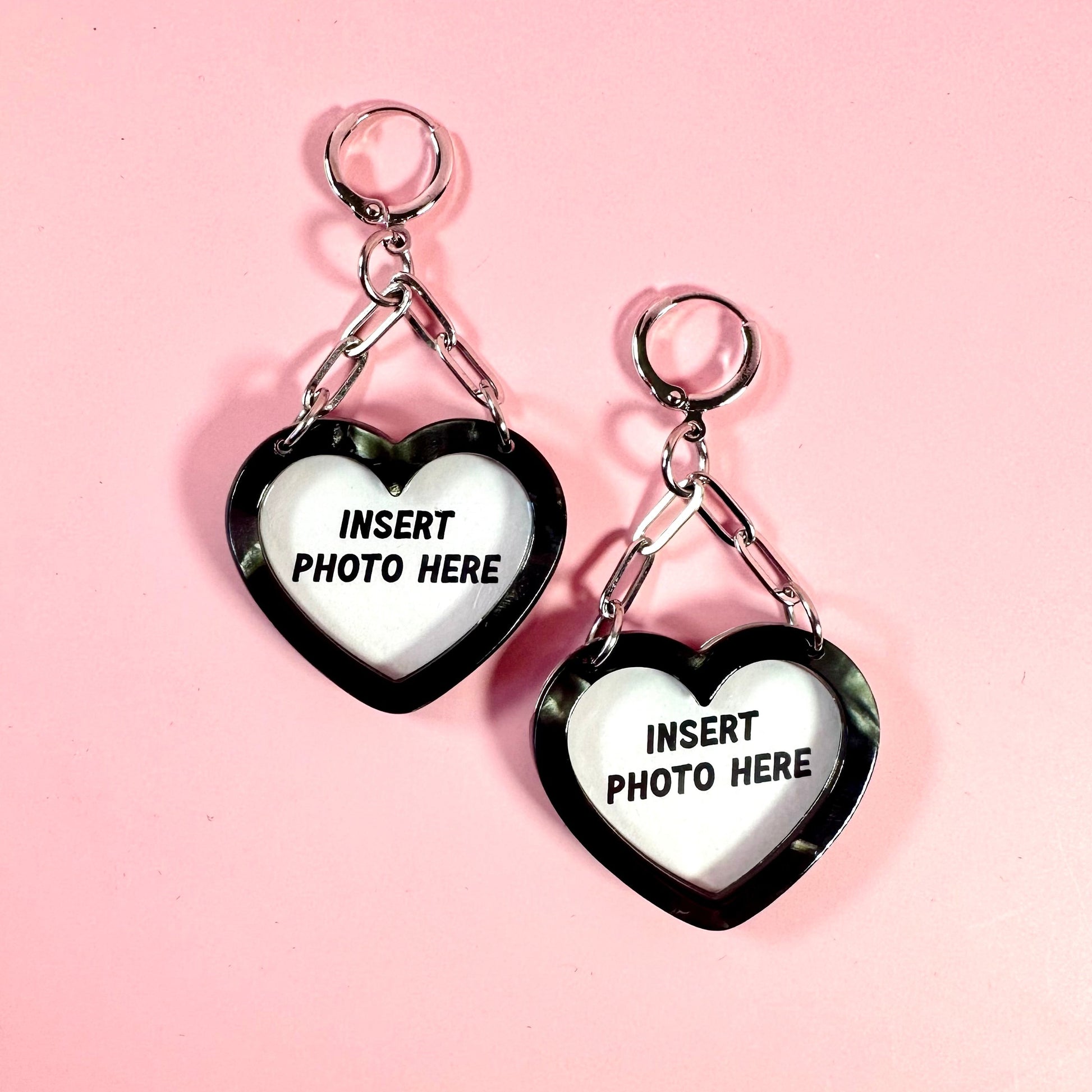 Heart-shaped keychains with 'Insert photo here' text on a pink background