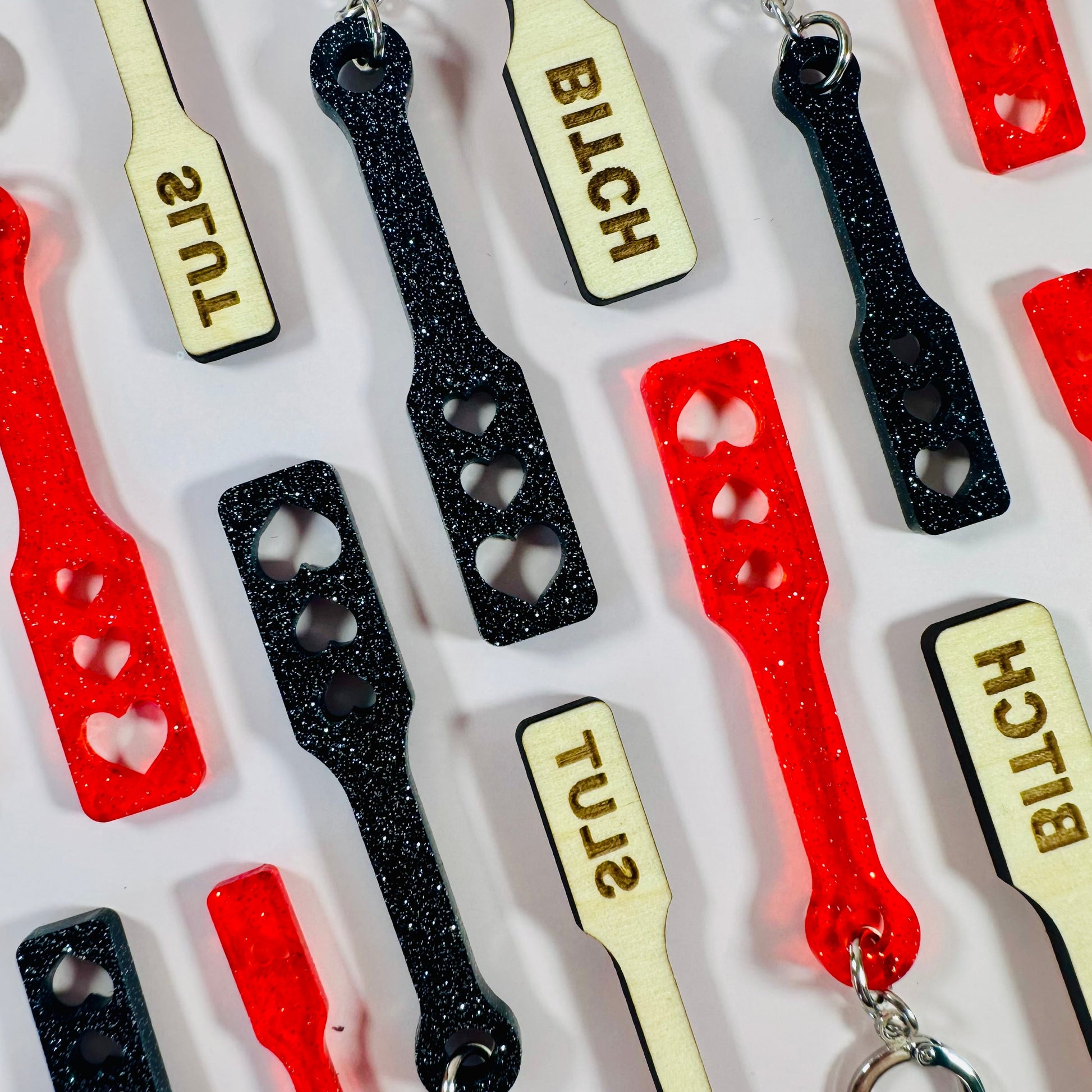 Keychains with various designs and text on a white background