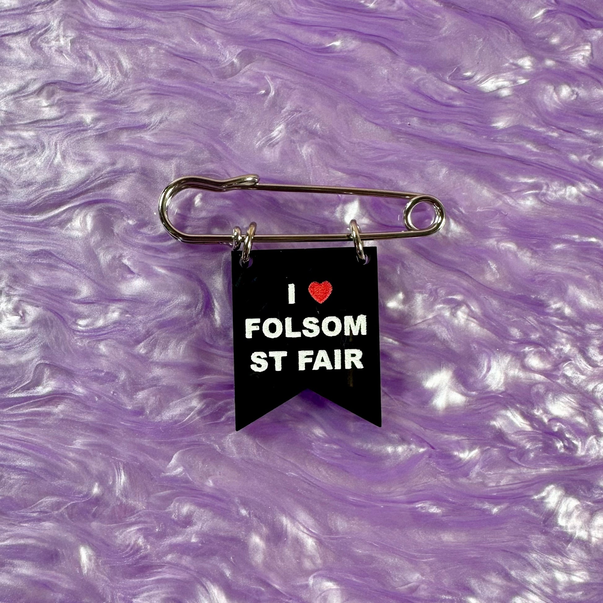 Black banner with 'I ❤️ FOLSOM ST FAIR' text on a purple marbled background