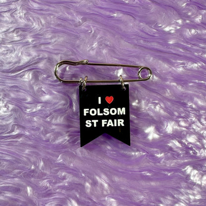 Black banner with 'I ❤️ FOLSOM ST FAIR' text on a purple marbled background