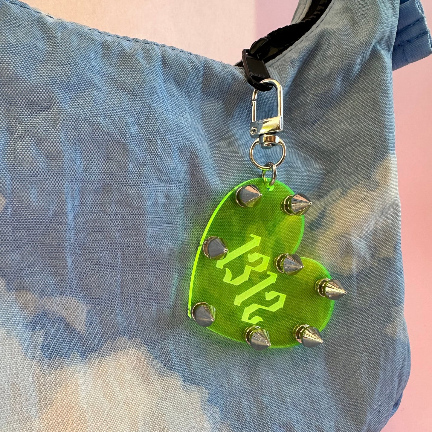 Green circular tag with spikes and '12' on a textured surface