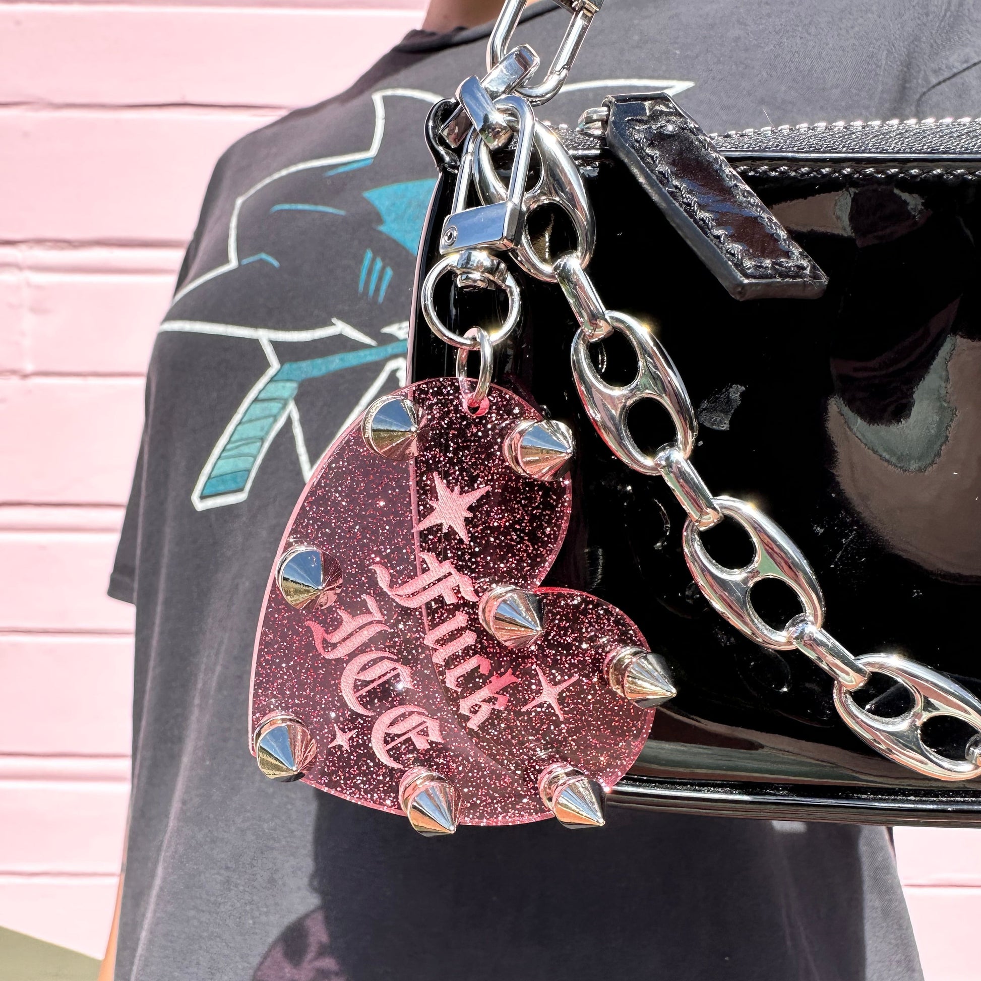 Heart-shaped keychain with 'Flick ICE' text on a black surface