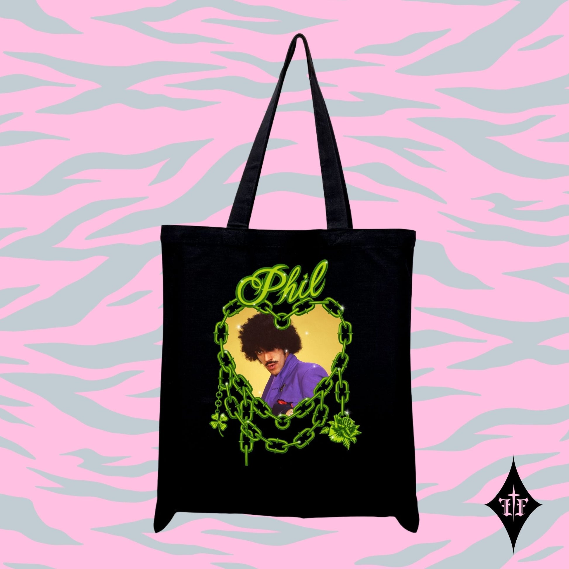Black tote bag with a graphic design of a person in a purple shirt and text 'Phil' on a pink and blue patterned background.