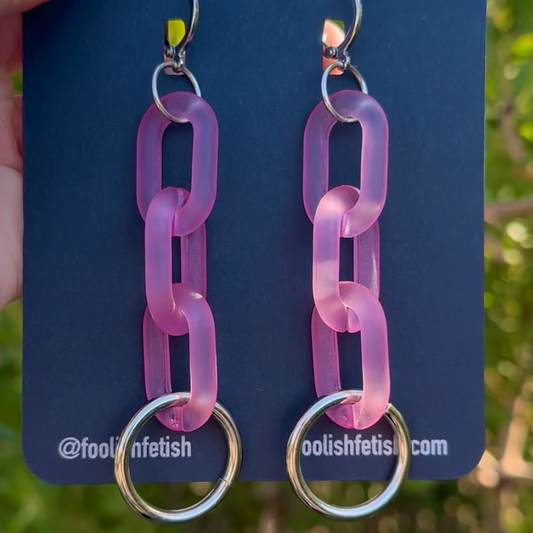 Pink chain link earrings on a blue card with 'foolishfetish' branding.