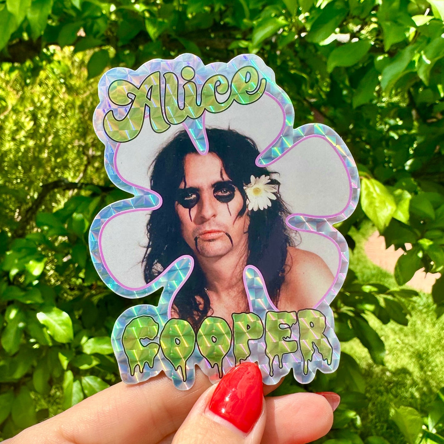 Sticker of Alice Cooper held in front of green foliage