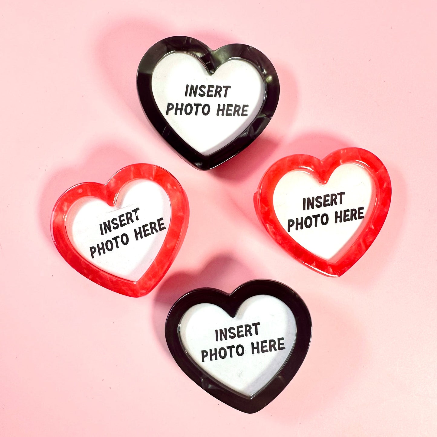 Heart-shaped photo frames with 'Insert Photo Here' text on a pink background