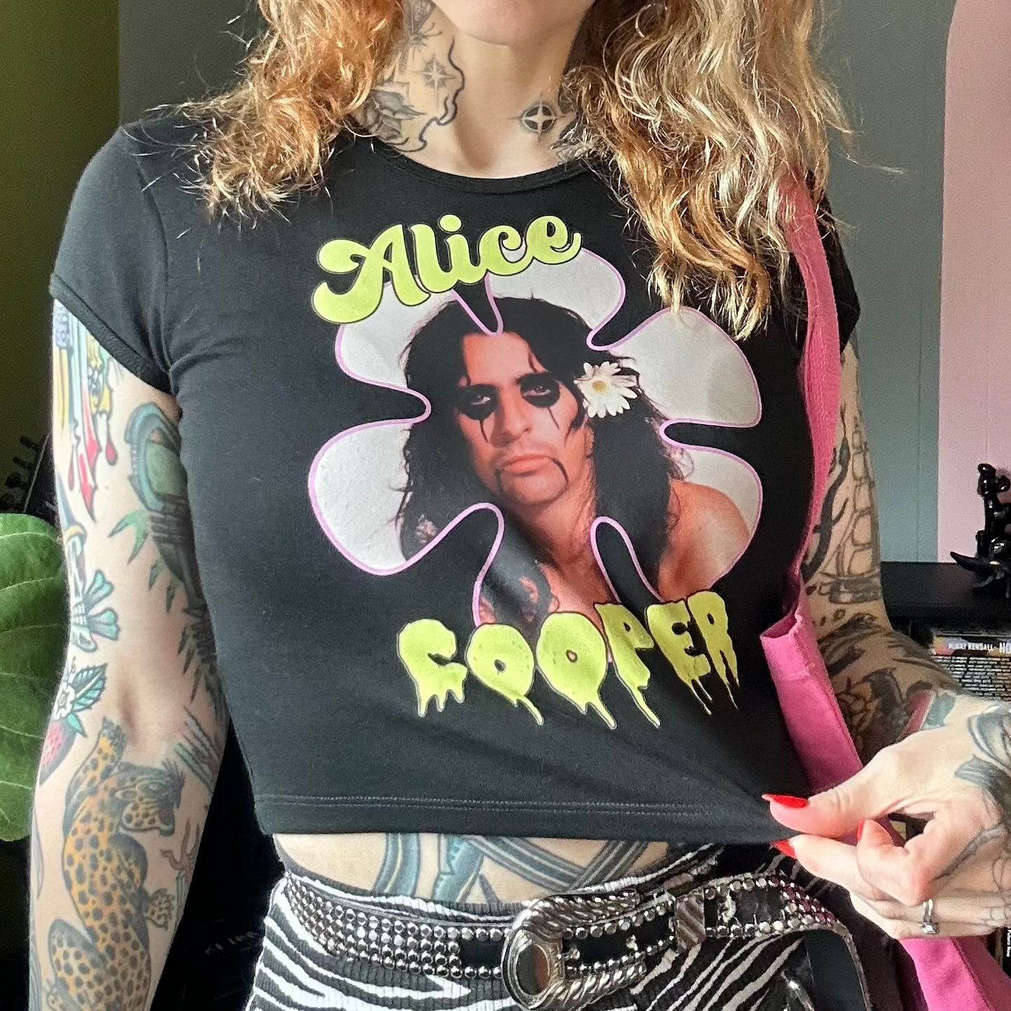 Person wearing a black t-shirt with 'Alice Cooper' design