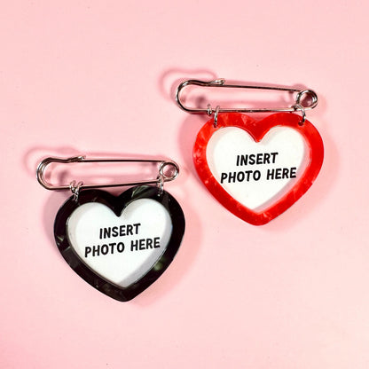 Two heart-shaped photo frames with 'Insert Photo Here' text on a pink background