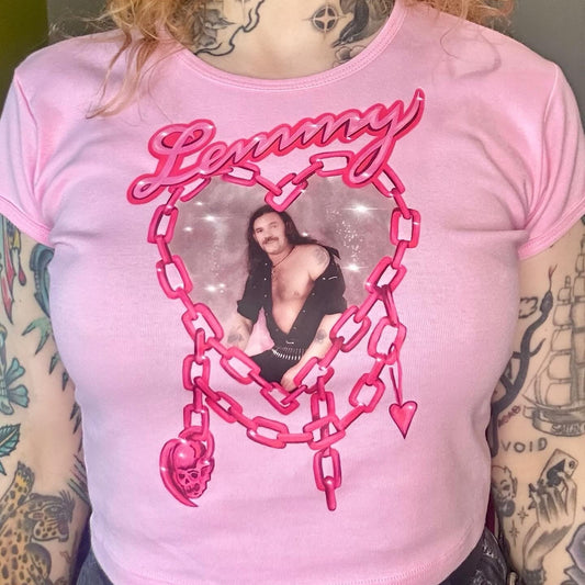 Person wearing a pink t-shirt with a graphic design and text.