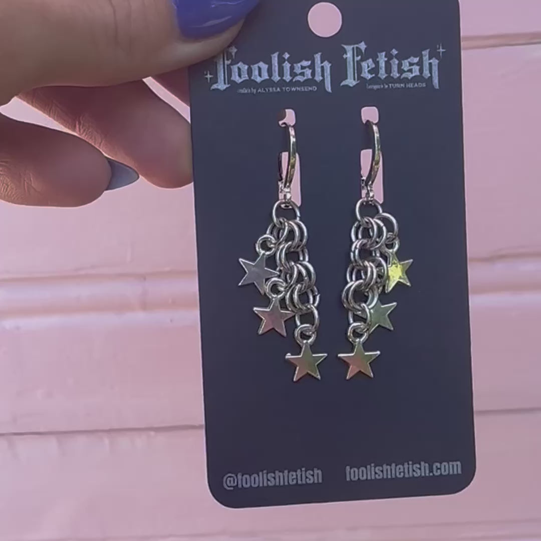 starry chainmaile earrings on black card backing