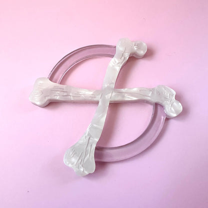 white crossbones circle scarf ring on pink background